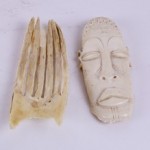 A white mask and a bone hand.