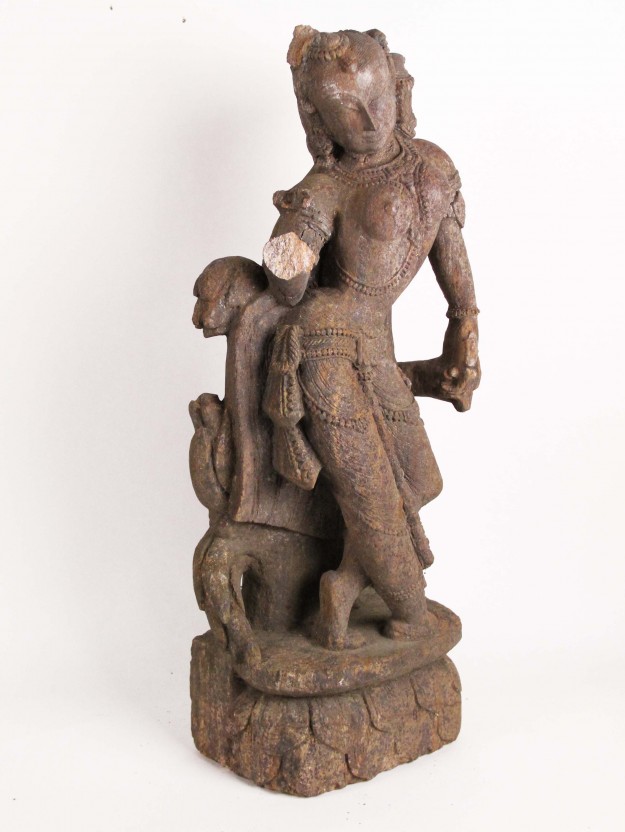 A statue of a man standing on top of a tree.