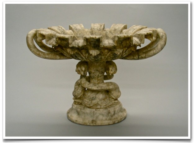 A marble bowl with a decorative design on it.