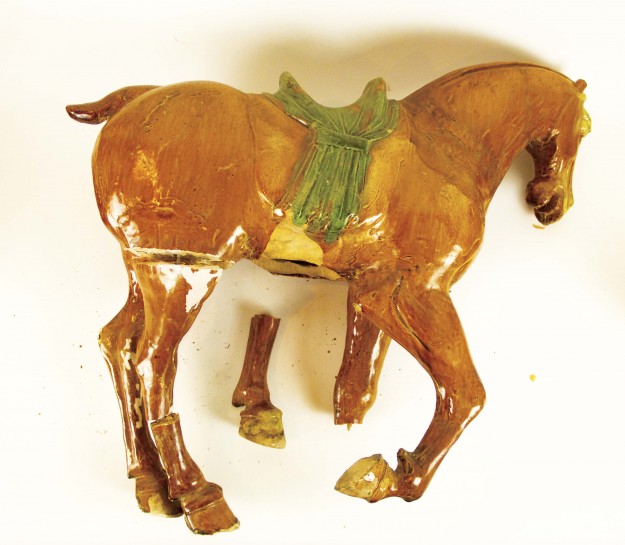 A horse with a saddle on its back.