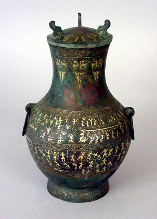 A large vase with a lid on top of it.