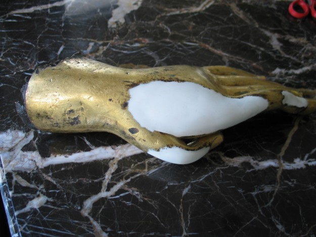 A banana peel with white wax on it.