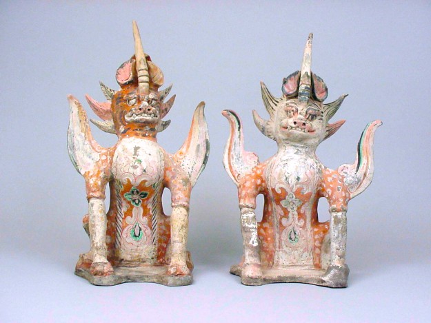 Two ceramic figurines of a dragon and a cat.