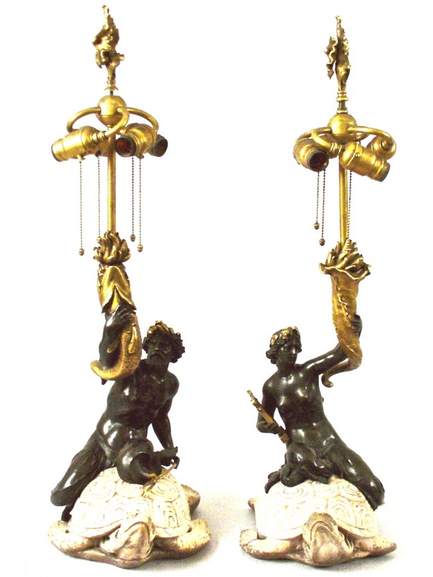 A pair of lamps with gold and black figures.
