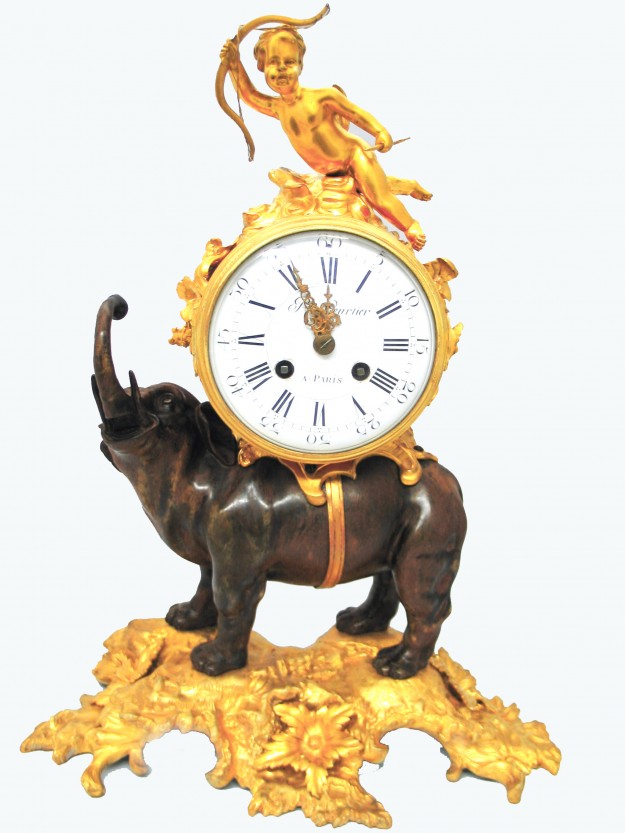 A clock mounted to an elephant statue.