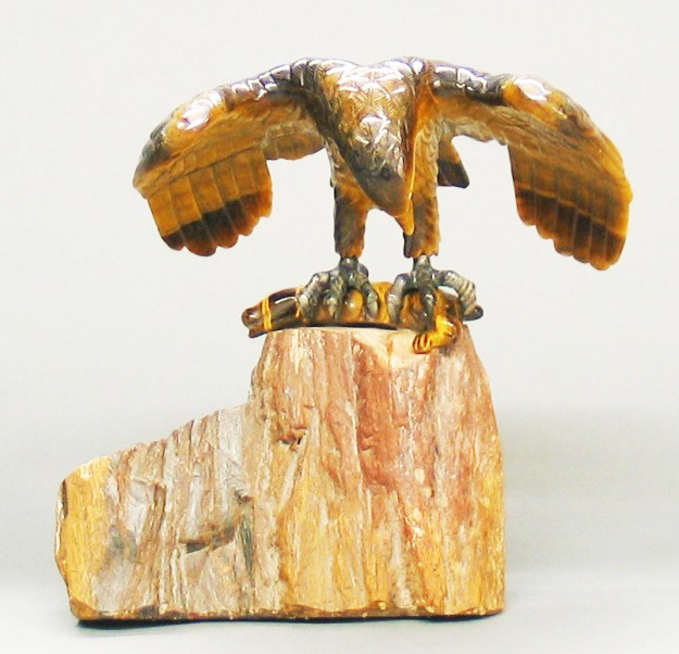 A bird sitting on top of a piece of wood.