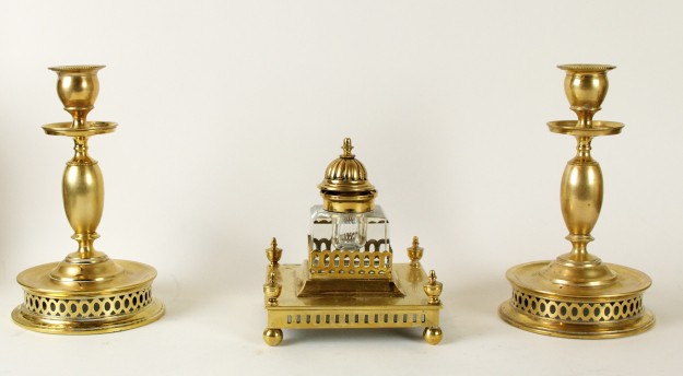 A gold colored statue with three different types of statues.