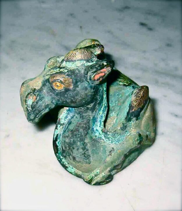 A green and gold statue of a horse.