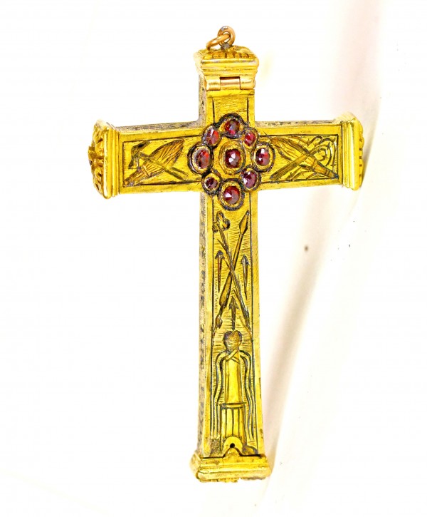 A cross with red stones on it.