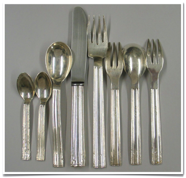 A group of silverware is shown on the table.