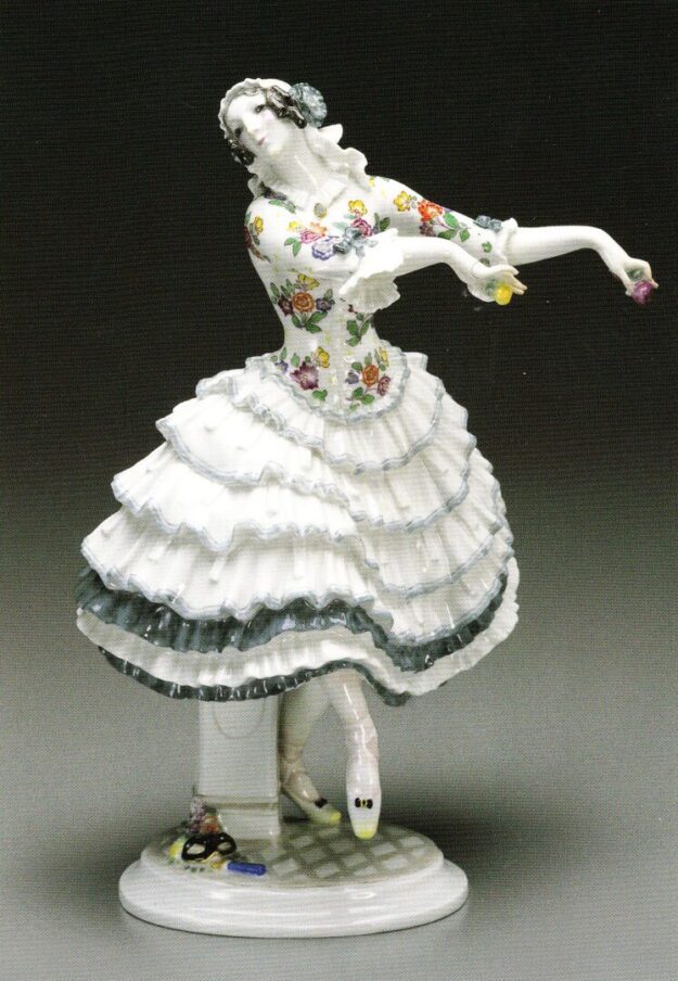 A porcelain figurine of a woman in a dress.