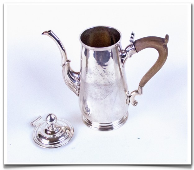 A silver coffee pot with wooden handles and lid.