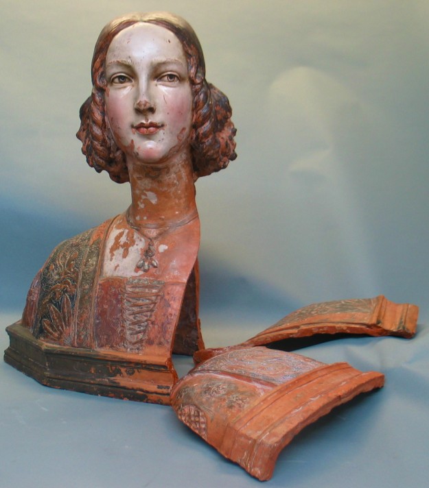 A statue of a woman with long hair and red lipstick.