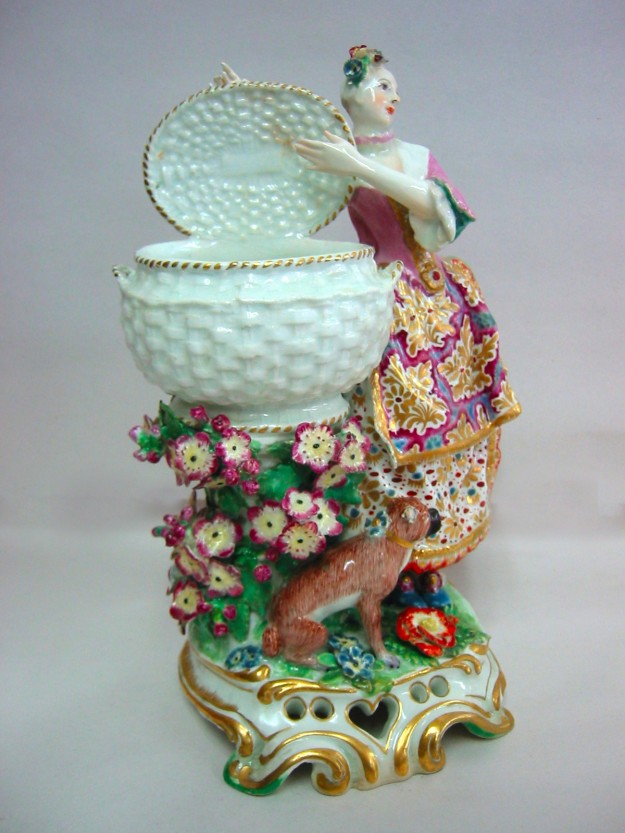 A statue of a woman holding a basket with flowers.