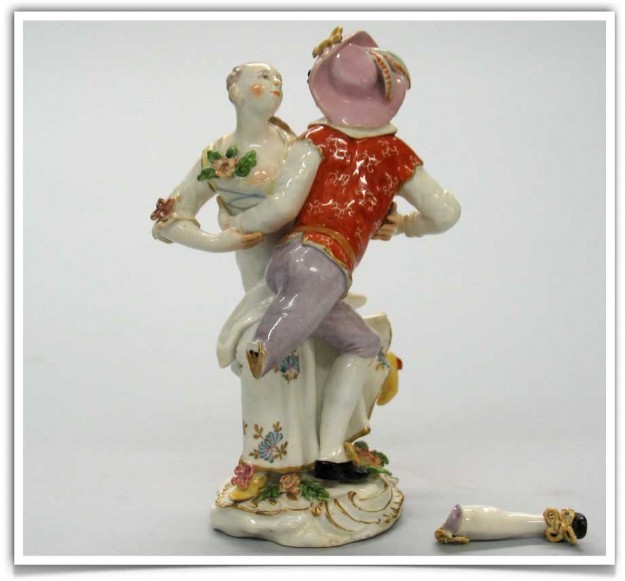 A figurine of two people dancing on top of each other.