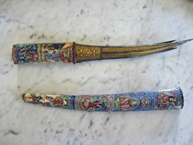 Two knives are sitting on a counter top.