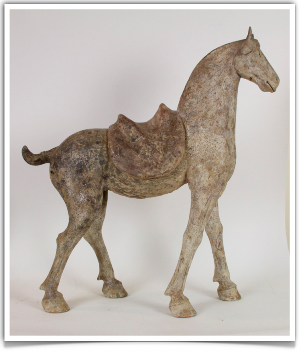 A horse statue with a saddle on its back.