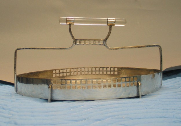 A metal tray with a handle on top of it.