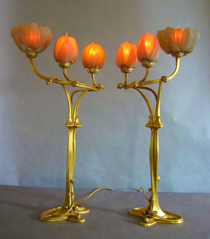 A pair of lamps with orange glass shades.